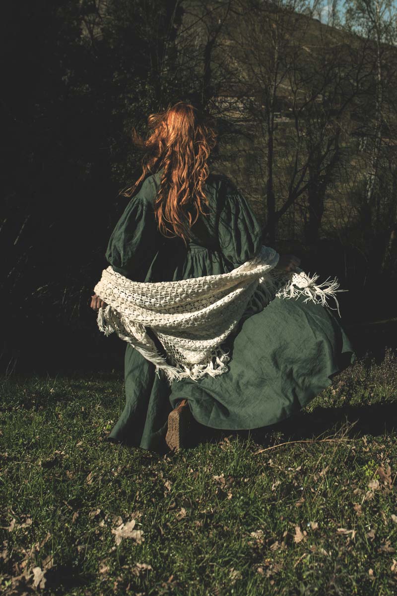 Rear view of a woman running through a field